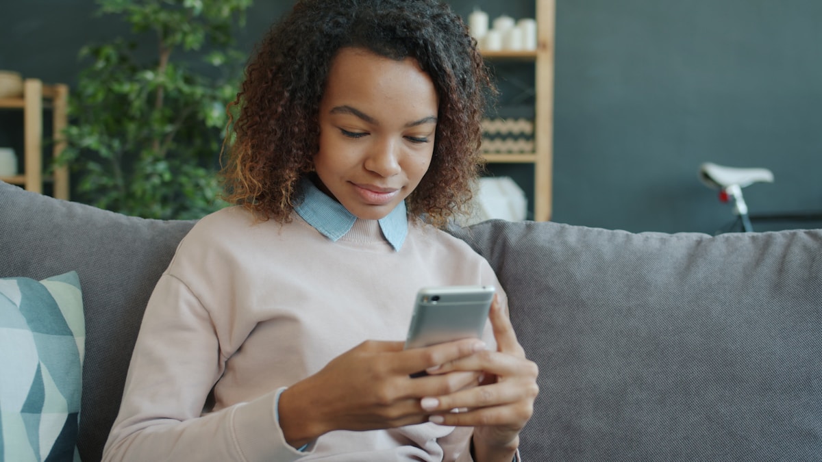 Woman using her phone on the couch